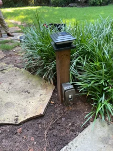 Electrical services professional installing outdoor light and electrical fixtures in Upstate SC